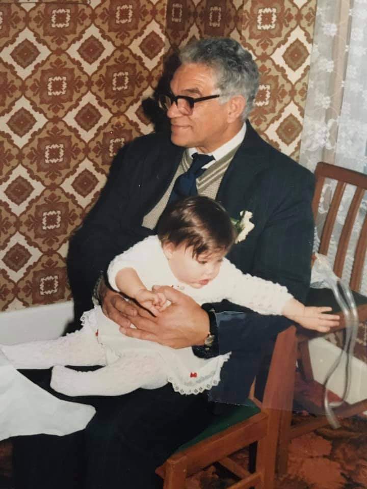 Charlie Hutchison at his son William's wedding, holding his grandaughter.
